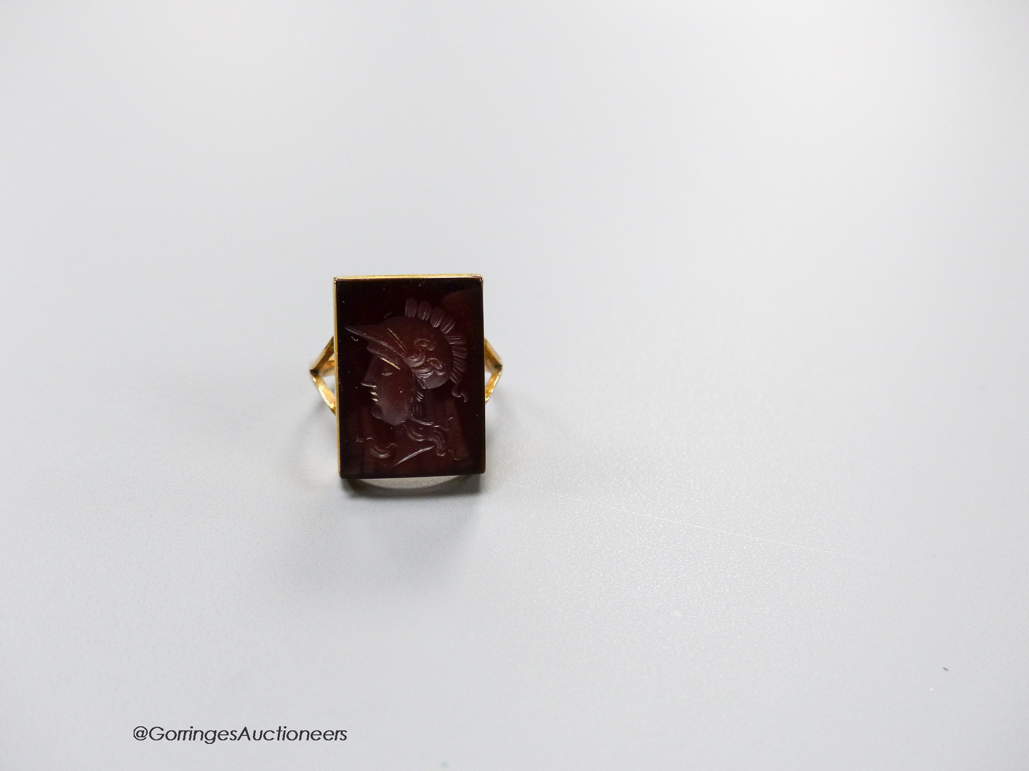 A 9ct yellow metal and intaglio hardstone signet ring, carved with the bust of a Roman soldier, size M, gross 4.1 grams.